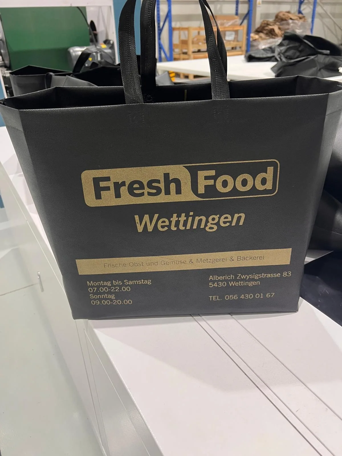 Finished black branded bag in a customer setting